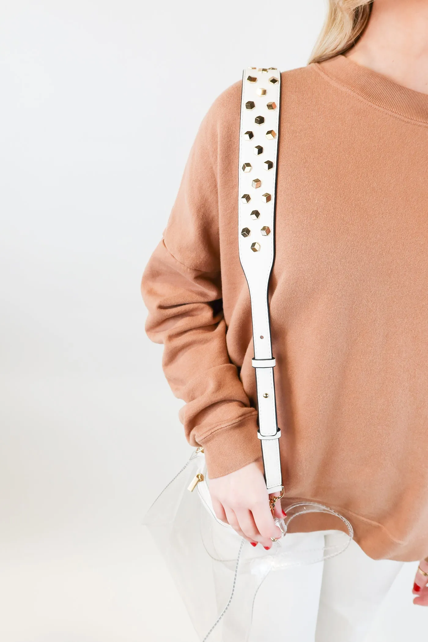 Clear bag with white studded shoulder strap