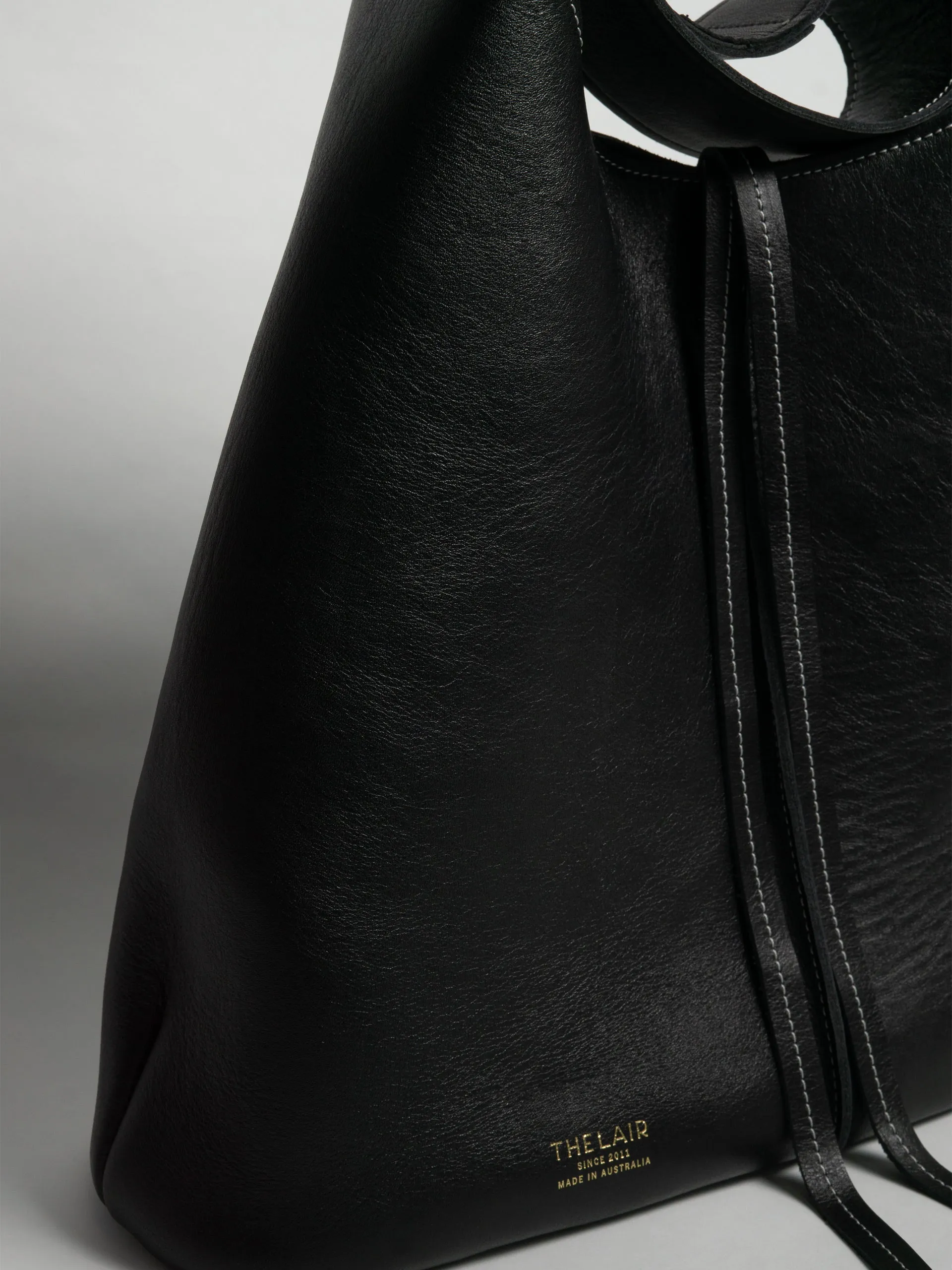 The Lair Suedo Sling Bag Large Black Gold